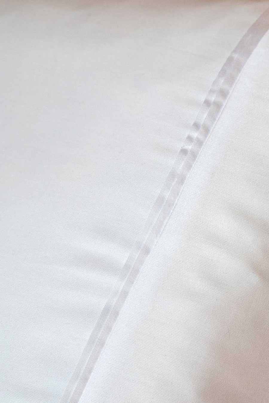 Detail of a white pillowcase in TENCEL™ Lyocell from THON.