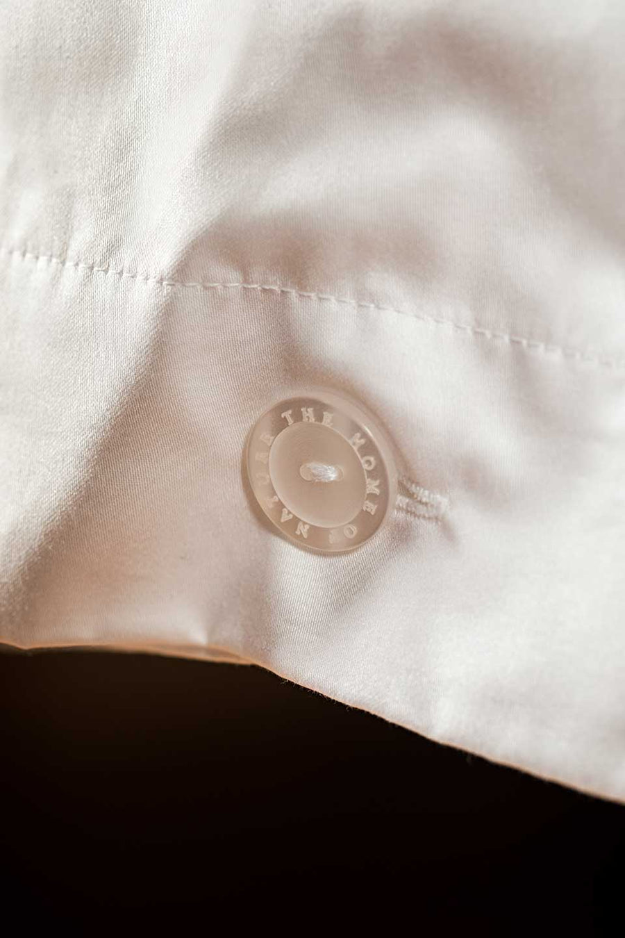 The Home of Nature button on a White Egyptian Cotton™ Sateen duvet cover.
