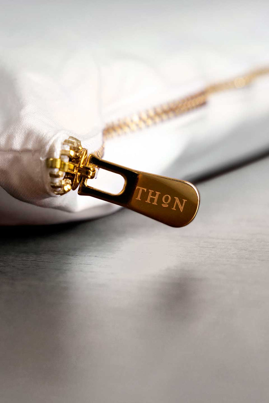 Golden zipper in an eco-friendly packaging in Egyptian Cotton™ Sateen from THON.
